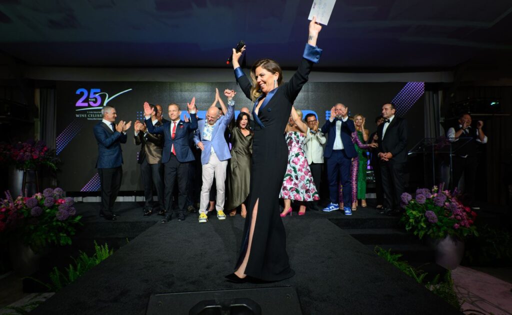 Event co-chair Amy Marks Dornbusch and the V Foundation Wine Celebration board of directors cheer the record $21 Million raised at the Gala Dinner & Auction.