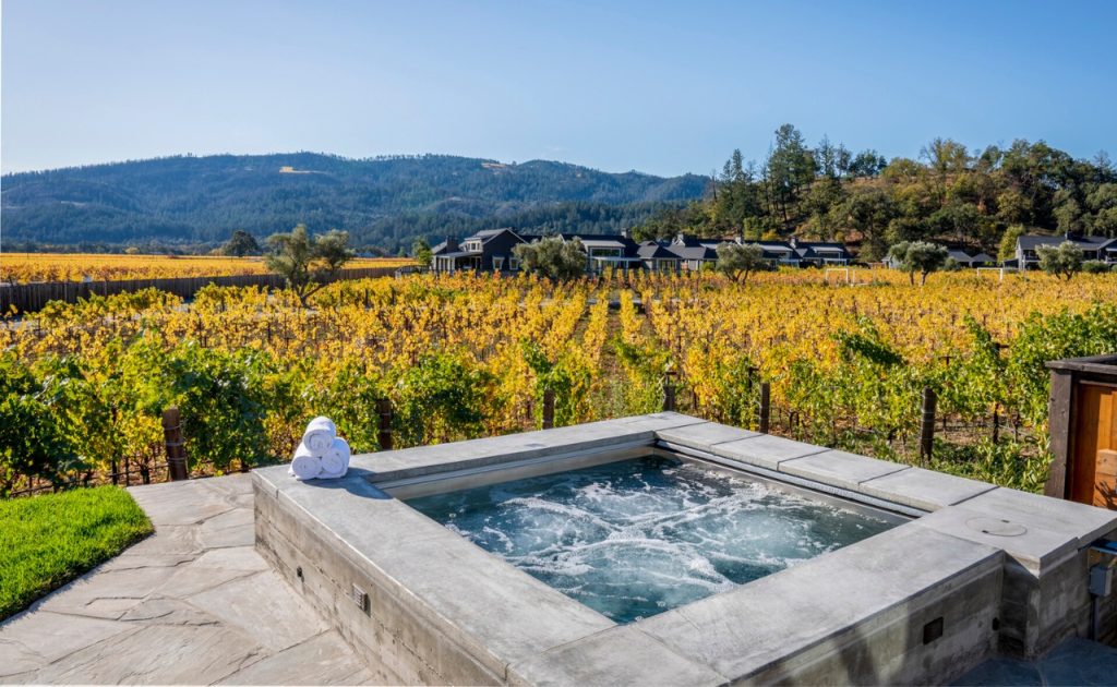 Hot tub with a gorgeous fall vineyard view at Four Seasons Napa Valley Villa & Residence Rentals