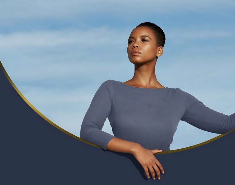 Confident woman standing in a modern circular frame, symbolizing empowerment and transformation with AVAVA.