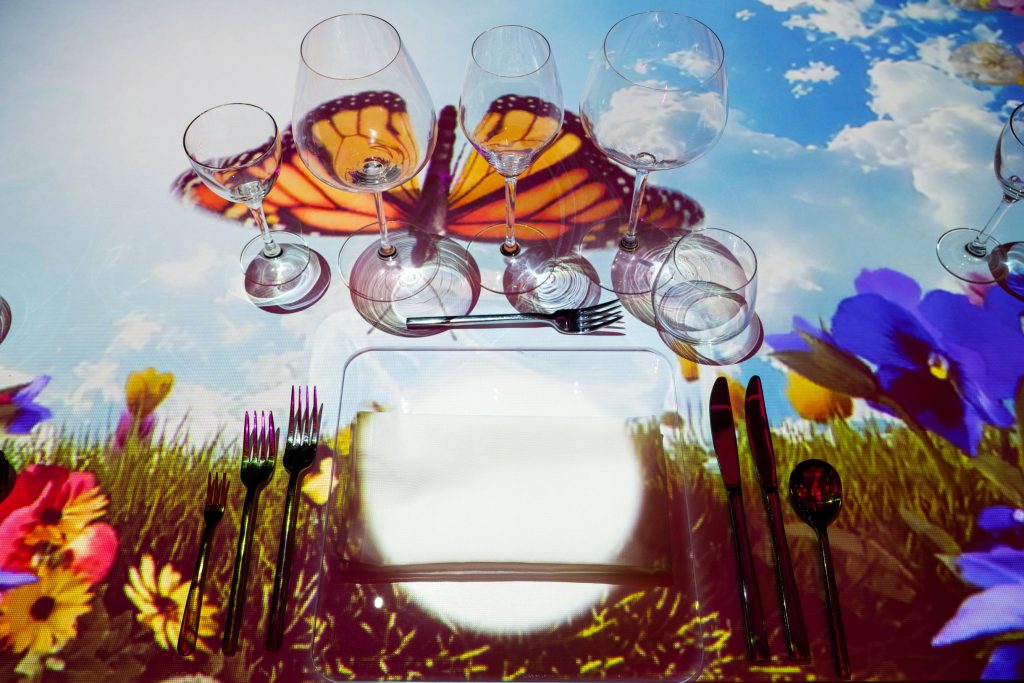 The Radiant Table place setting with butterfly and floral projection display