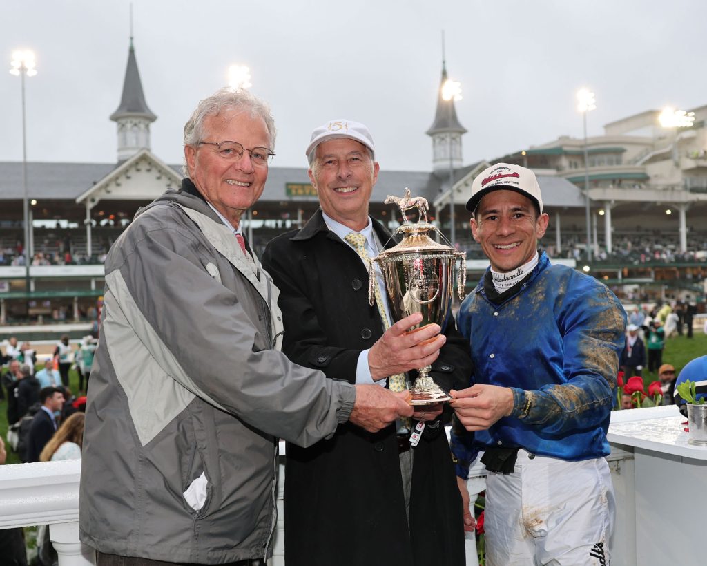 Bill Mott, Godolphin’s Michael Banahan, and Junior Alvarado celebrating Sovereignty’s Kentucky Derby win