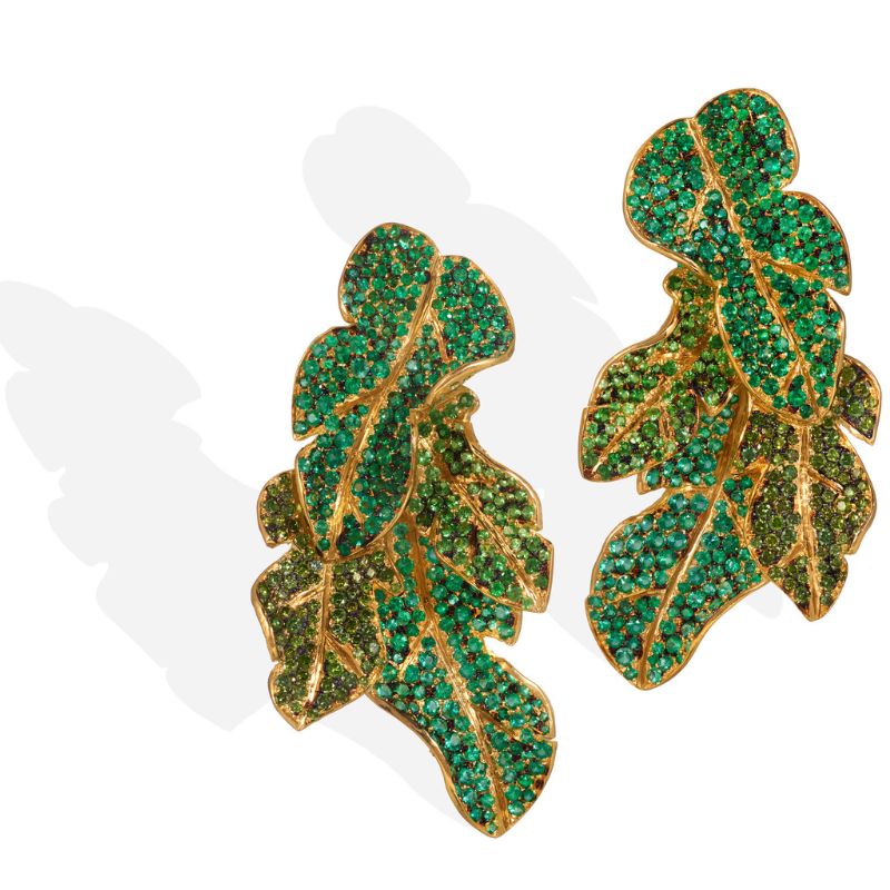 Luxury leaf-shaped gold earrings adorned with sparkling green gemstones, elegant nature-inspired jewelry design