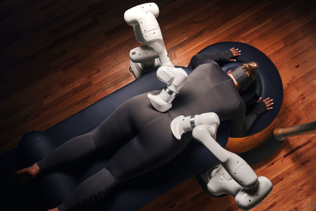 AI-powered robotic massage arms giving a full-body treatment session