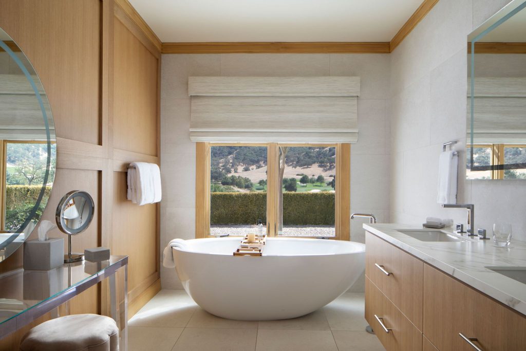 Elegant bathroom at CordeValle featuring a deep soaking tub with scenic views of the rolling California hills.