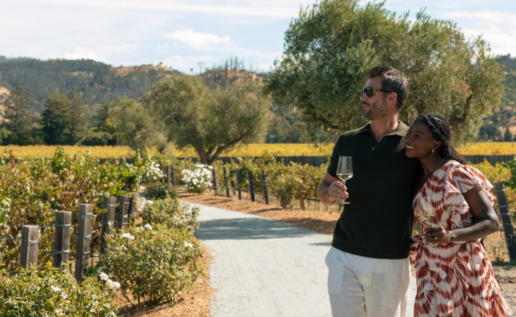 Guests walking through vineyard at Four Seasons Resort and Residences Napa Valley.