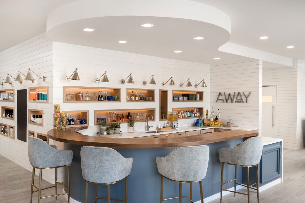 Chic AWAY Spa bar area with modern seating and luxury wellness products